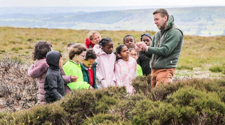 A group of children listening to a lets learn moor talk