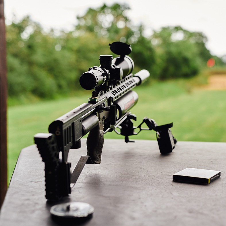 An air rifle aiming down a range